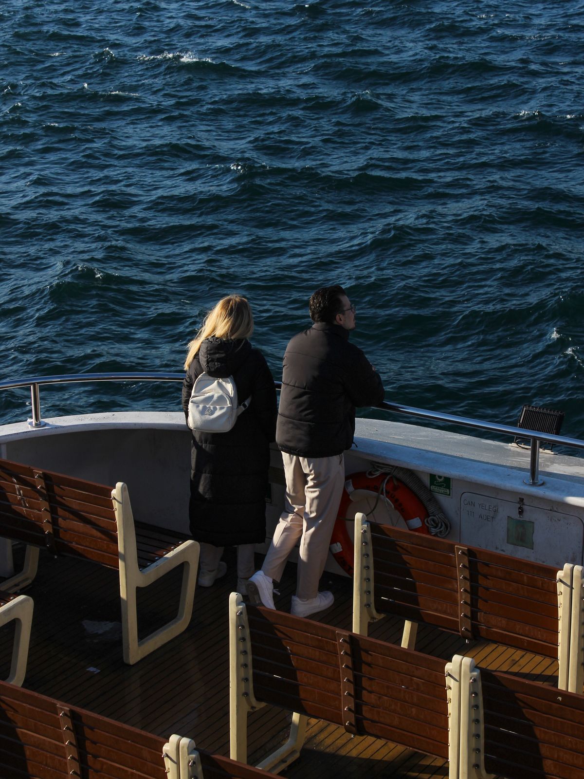 Couple watching the sea from a ship deck