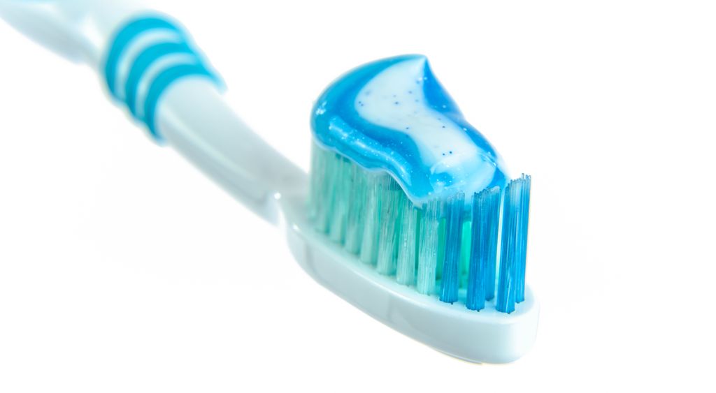 Toothbrush with a stripe of toothpaste on the bristles