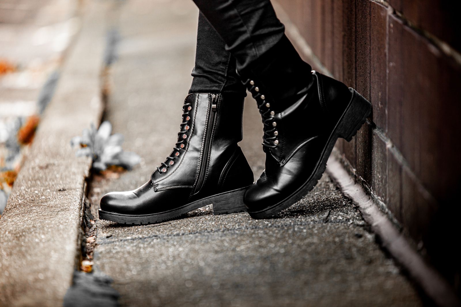 Black lace-up ankle boots on a pavement
